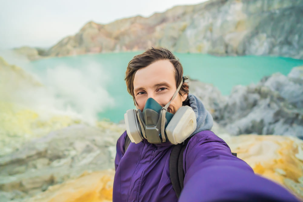 A man in fron of Ijen Acid Lake